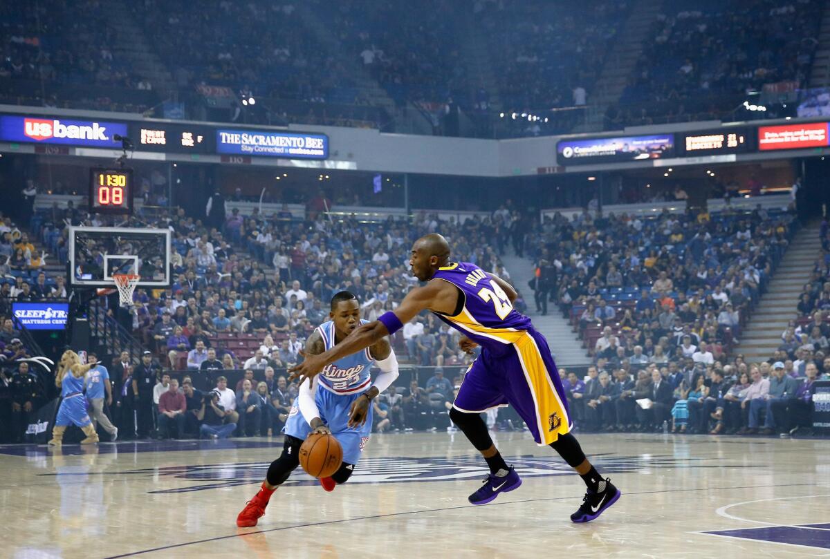 Sacramento's Ben McLemore is fouled by the Lakers' Kobe Bryant at Sleep Train Arena on Friday.