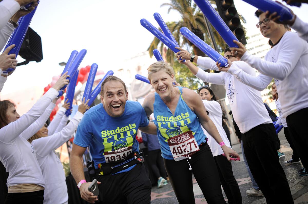 Sanjin and Sarah Gacina of Los Angeles celebrate renewing their wedding vows at mile 10 of the L.A. Marathon.