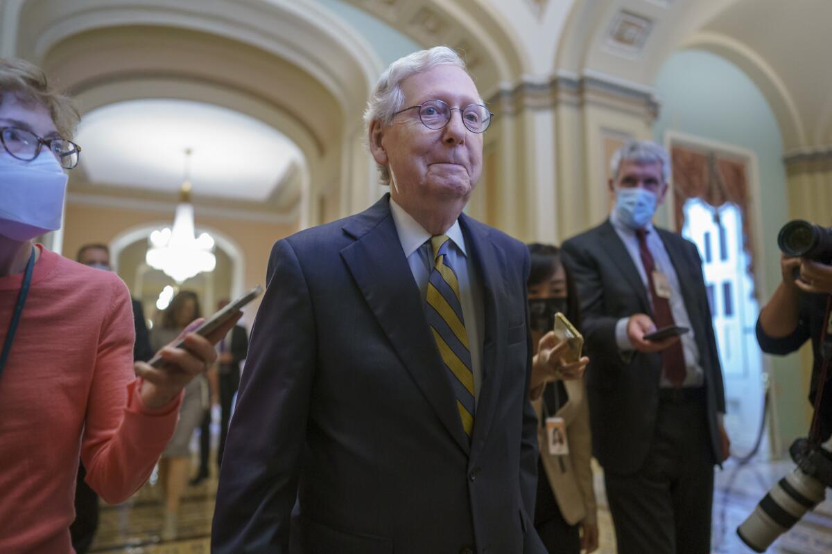 Senate Minority Leader Mitch McConnell is surrounded by journalists