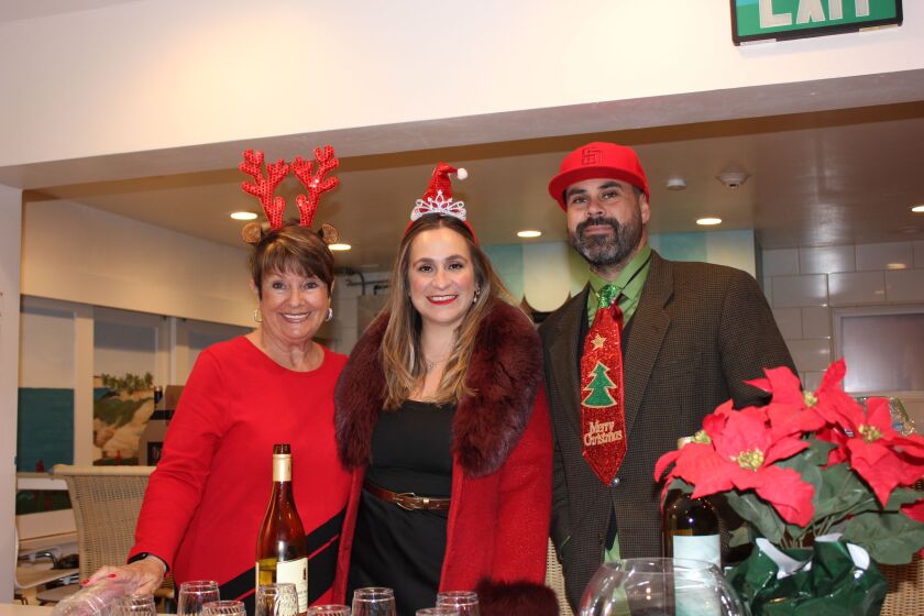 Denise Casey, Hila de Anda and Joseph Walters don their festive finest for the La Jolla Community Center holiday party.