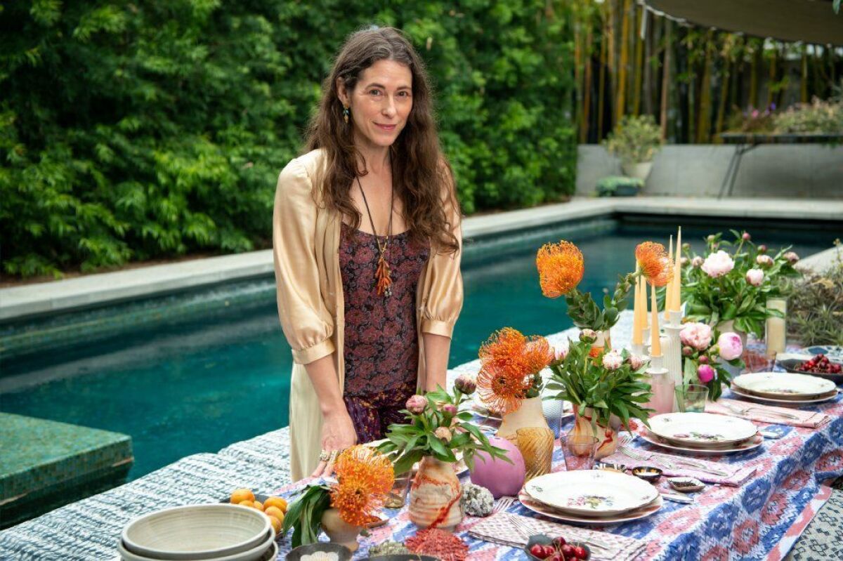 Liseanne Frankfurt setting the table for an afternoon lunch party at her Mar Vista home.