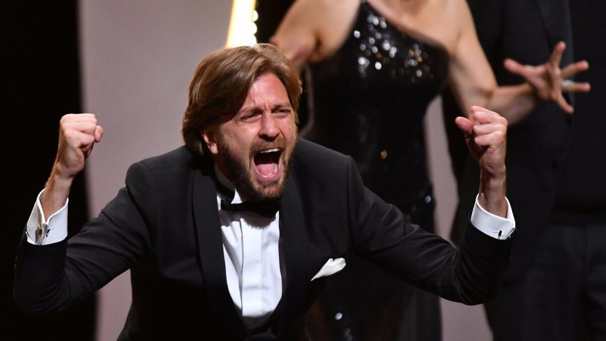 Swedish director Ruben Ostlund reacts on stage after he was awarded with the Palme d'Or for the film 'The Square' during the closing ceremony of the 70th edition of the Cannes Film Festival.