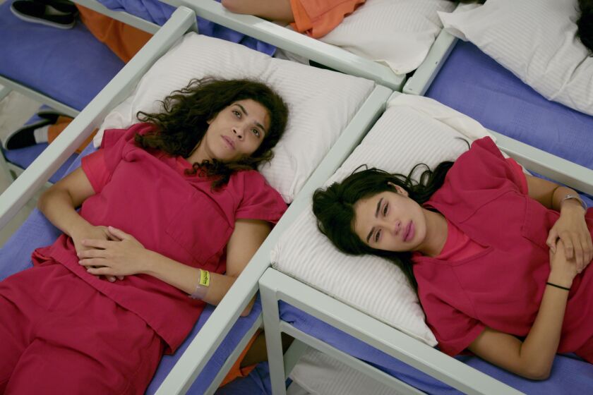 Laura Gomez and Diane Guerrero in a scene from ORANGE IS THE NEW BLACK, season 7.
