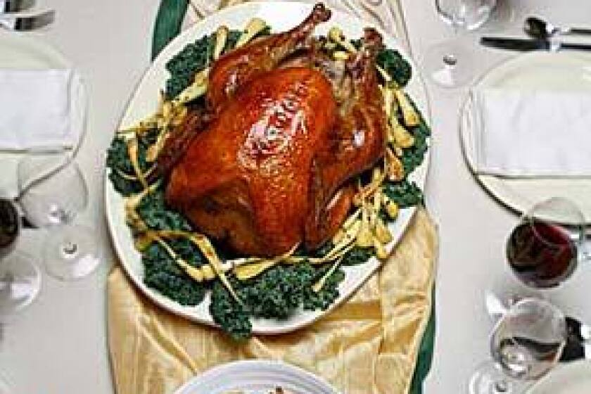 Salt-rubbed, roasted turkey with roasted parsnips, center, braided rosemary and black pepper bread with warm cheese, top, and mushroom walnut stuffing, bottom, are part of the Thanksgiving table.