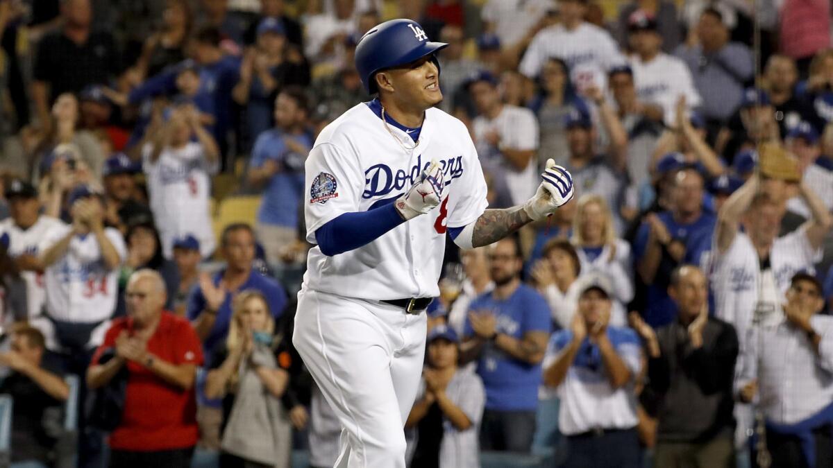 Dodgers shortstop Manny Machado gestures to the crowd after hitting a solo home run against the Diamondbacks.