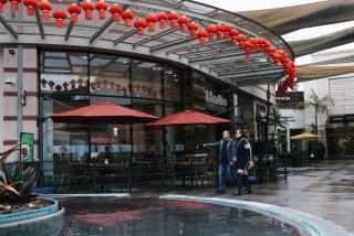 Los Angeles, CA - January 09: People walk along the promenade at the Shops at Santa Anita on Monday, Jan. 9, 2023 in Los Angeles, CA. Strip malls like this one in LA's Chinese suburbs are undergoing a renovation that cater to high-end tourists with international brands and a semi-assimilated population of upper middle class Chinese Americans in the suburbs. (Dania Maxwell / Los Angeles Times)