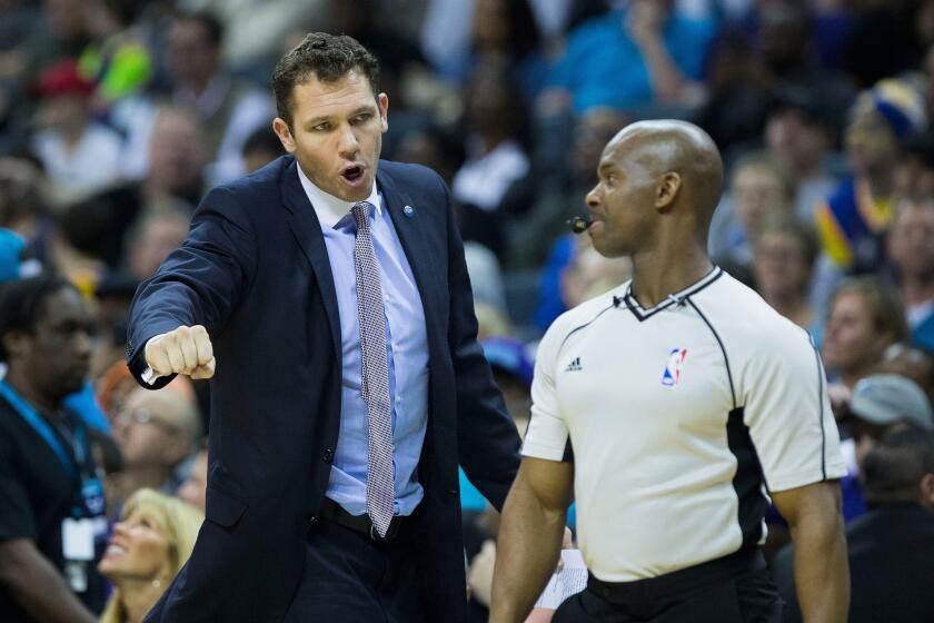 Lakers Coach Luke Walton, arguing a call while the Warriors' interim coach, is reportedly on the verge of making another hire for his coaching staff.