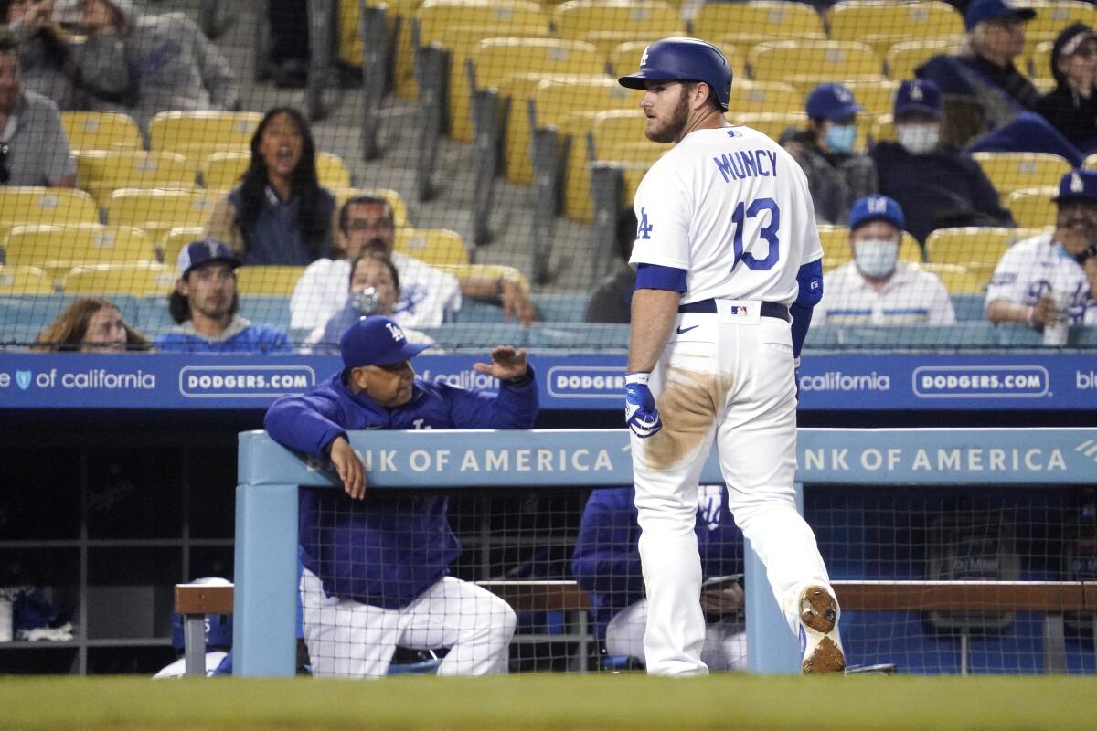 The Dodgers' Max Muncy looks toward home plate as he walks off the field after flying out.
