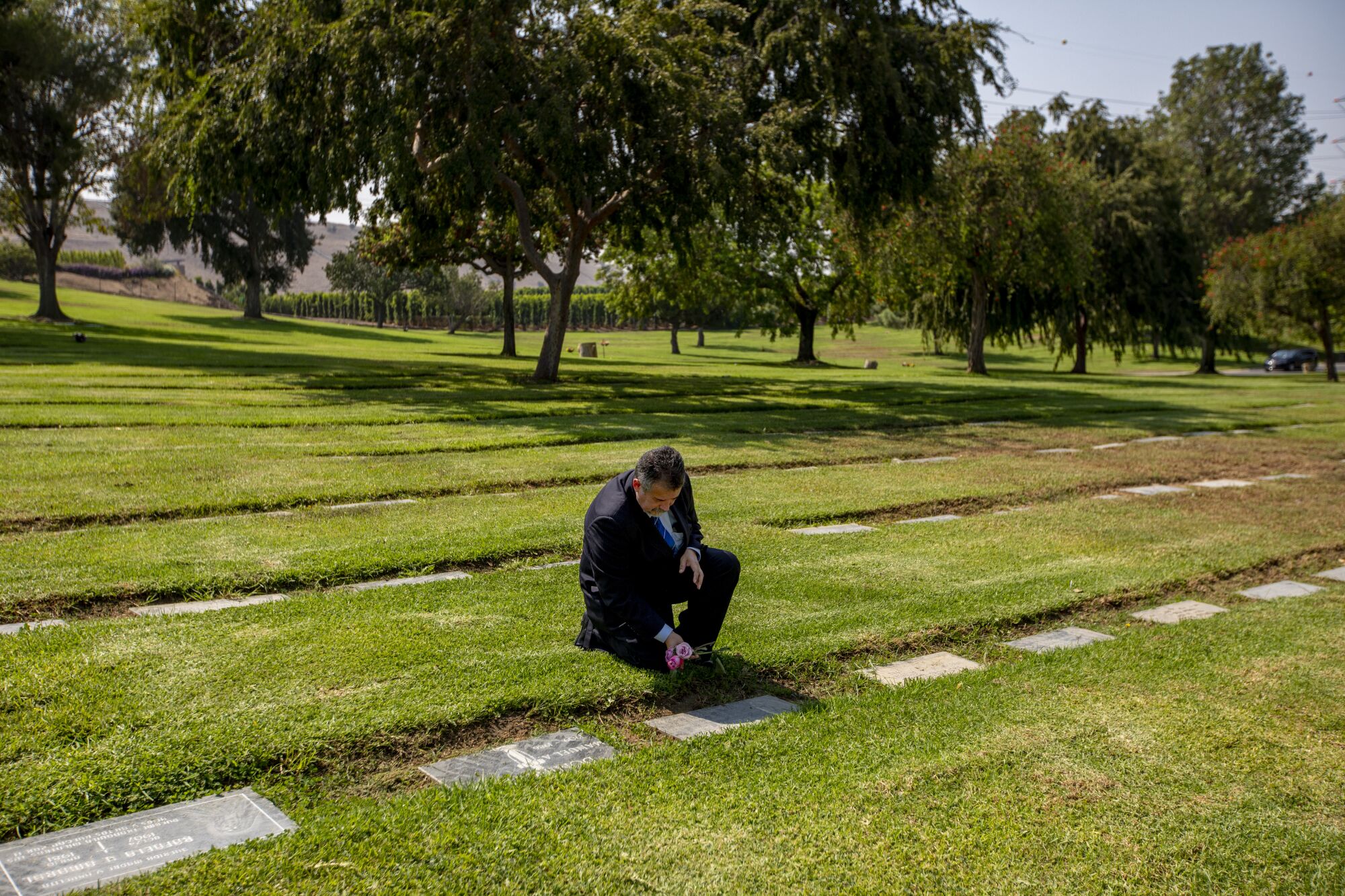 Trino Jimenez visits his brother's grave at Resurrection Cemetery in Rosemead.