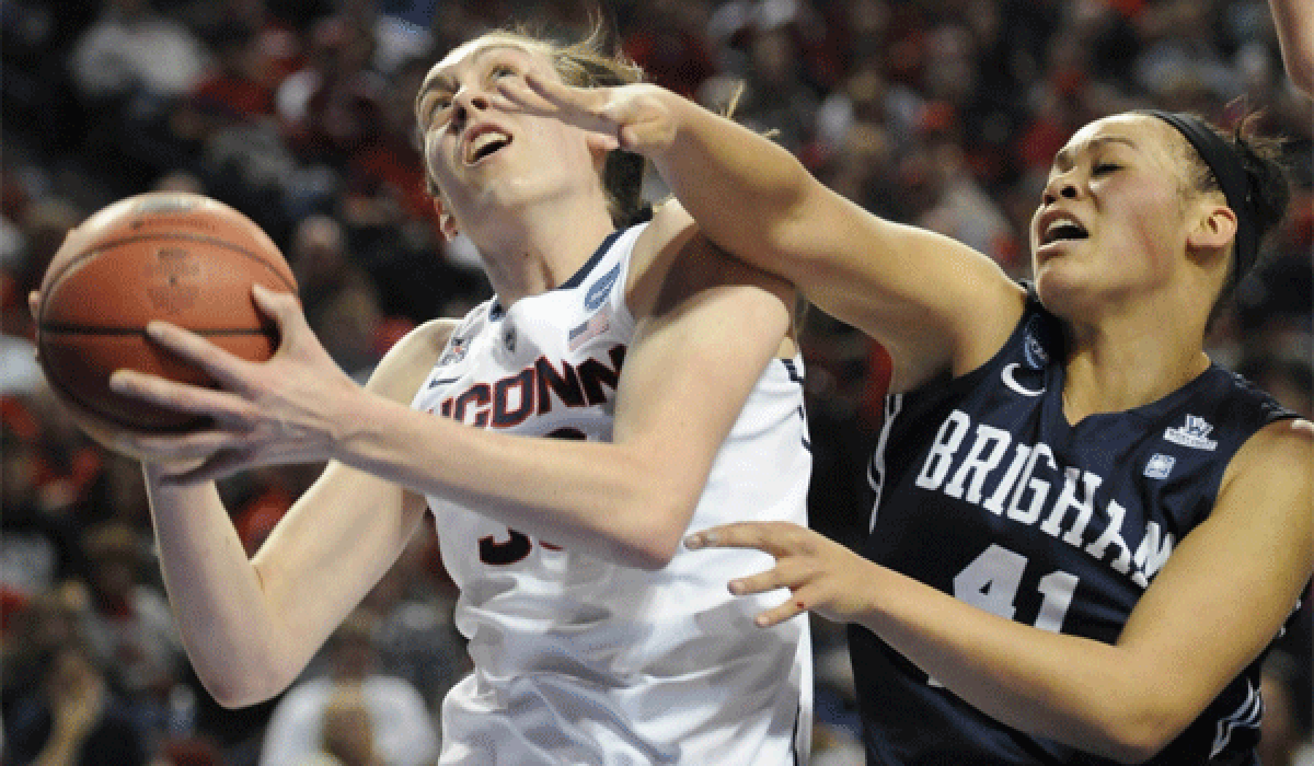 Connecticut's Breanna Stewart is defended by Brigham Young's Morgan Bailey during the Huskies' 70-51 victory Saturday at the Pinnacle Bank Arena in Lincoln, Neb.