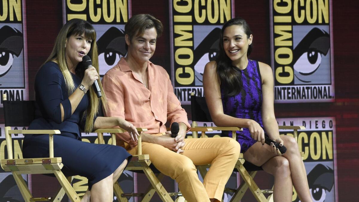 Patty Jenkins, left, Chris Pine and Gal Gadot speak at the panel for "Wonder Woman 1984" at Comic-Con International on Saturday in San Diego.