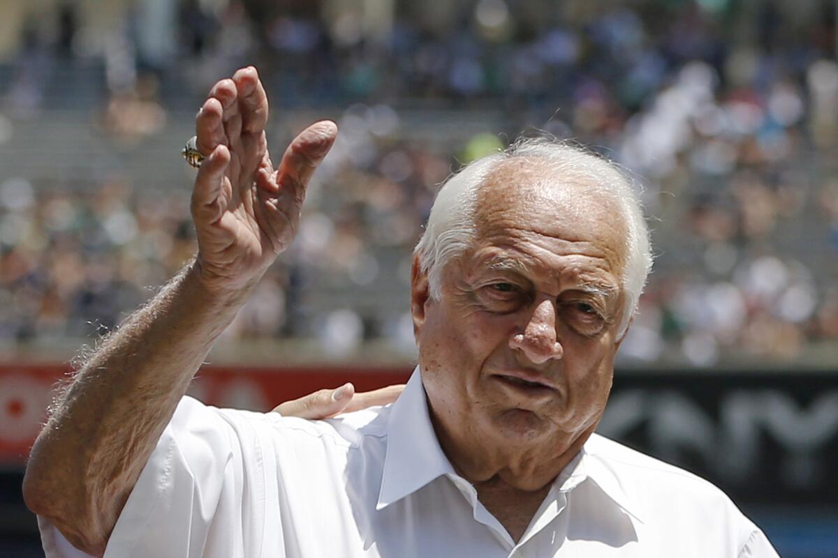 Hall of Fame manager Tommy Lasorda waves to the crowd before a baseball game at Yankee Stadium.