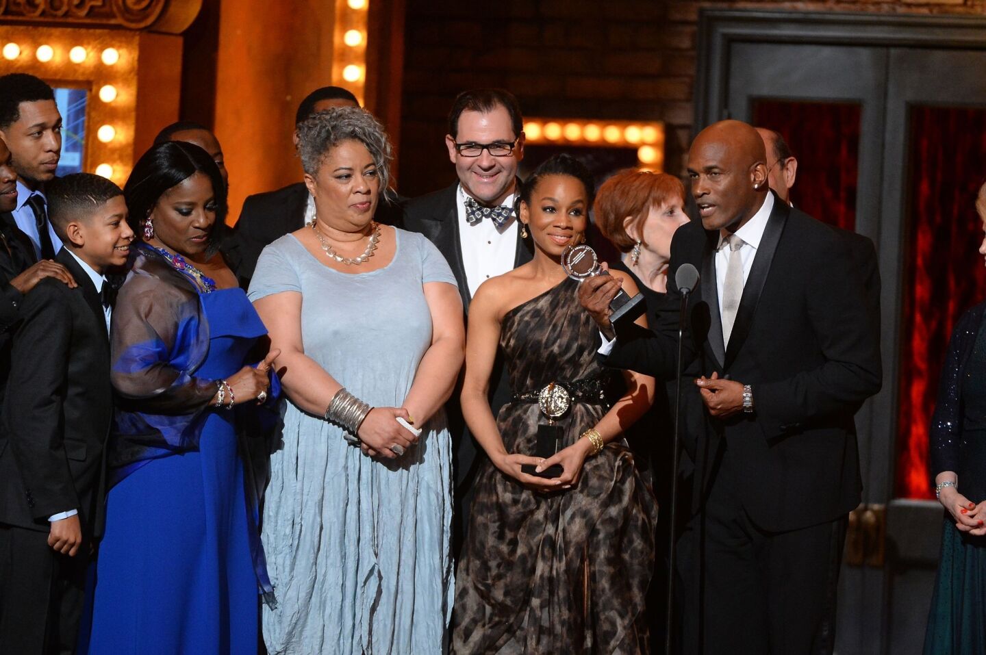 Director Kenny Leon, right, speaks onstage alongside the cast of "A Raisin in the Sun," which won best revival of a play.