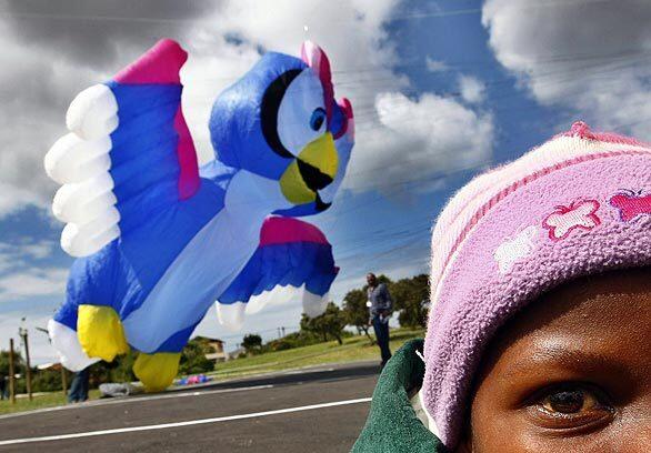 Special needs children from Cape Mental Health's Imizamo Yethu Special Care Center play with kites in Khayelitsha, Cape Town on Thursday. As part of the Cape Town International Kite festival being held this week, professional kiters from Germany, the United Kingdom and South Africa arranged a preview for the mentally disabled children. Integration and inclusion of people with intellectual and psychiatric disabilities is a key component of the work done by the Cape Mental Health society, which sponsors the biggest kite festival in Africa.