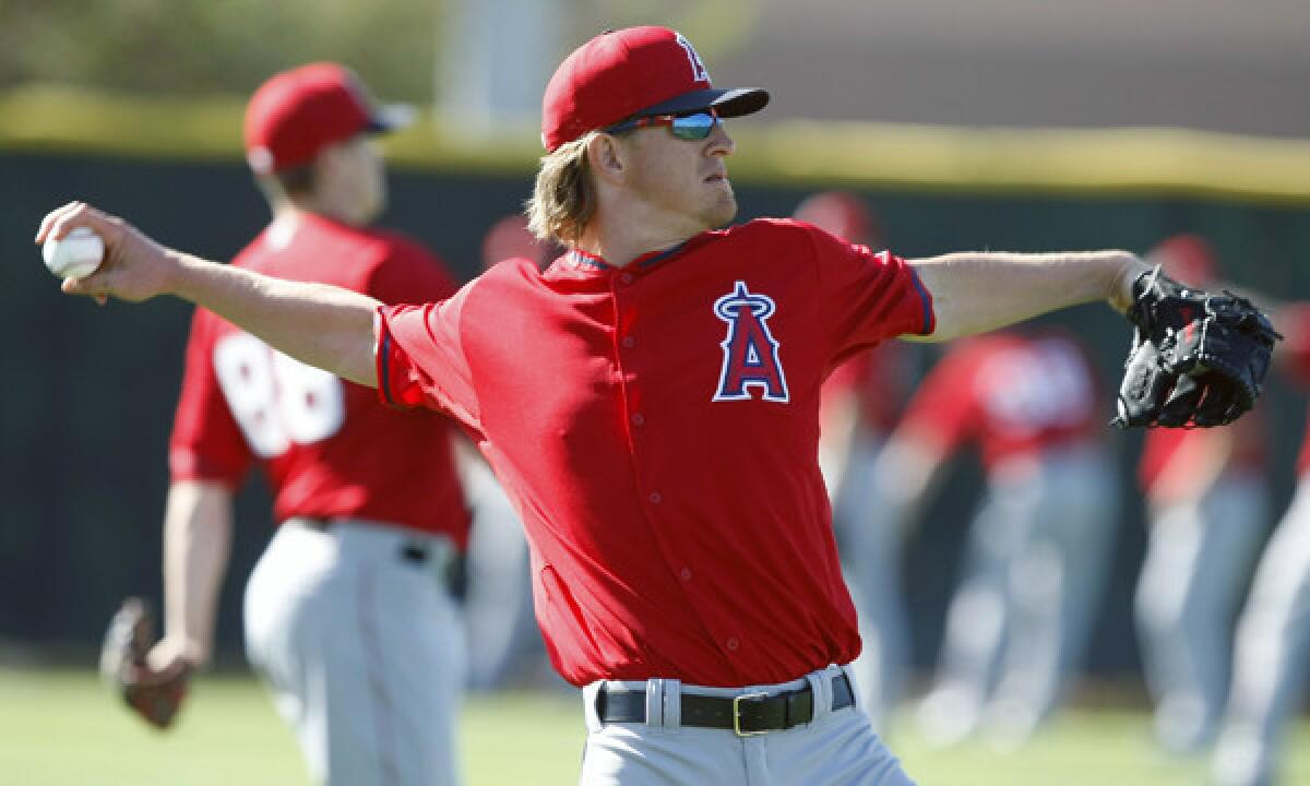 Angels pitcher Jered Weaver warms up during a spring training practice session on Feb. 20.