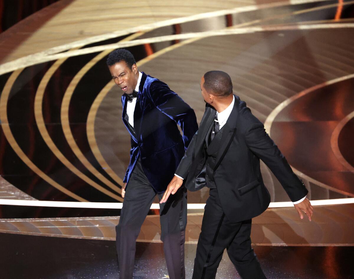 Will Smith slapping Chris Rock onstage at the 2022 Oscars