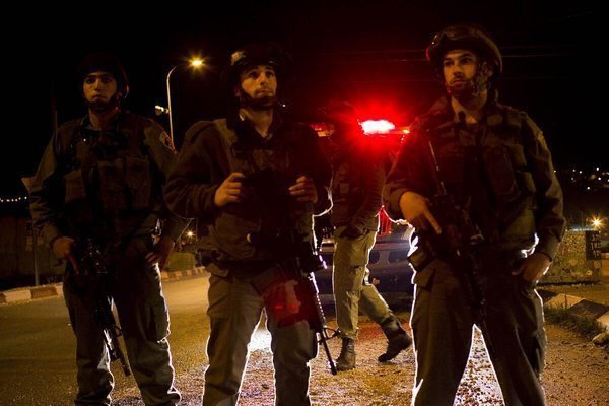 Israeli soldiers guard an entrance to the Jewish settlement of Itamar in 2011 after a Palestinian infiltrated the settlement and killed five people.