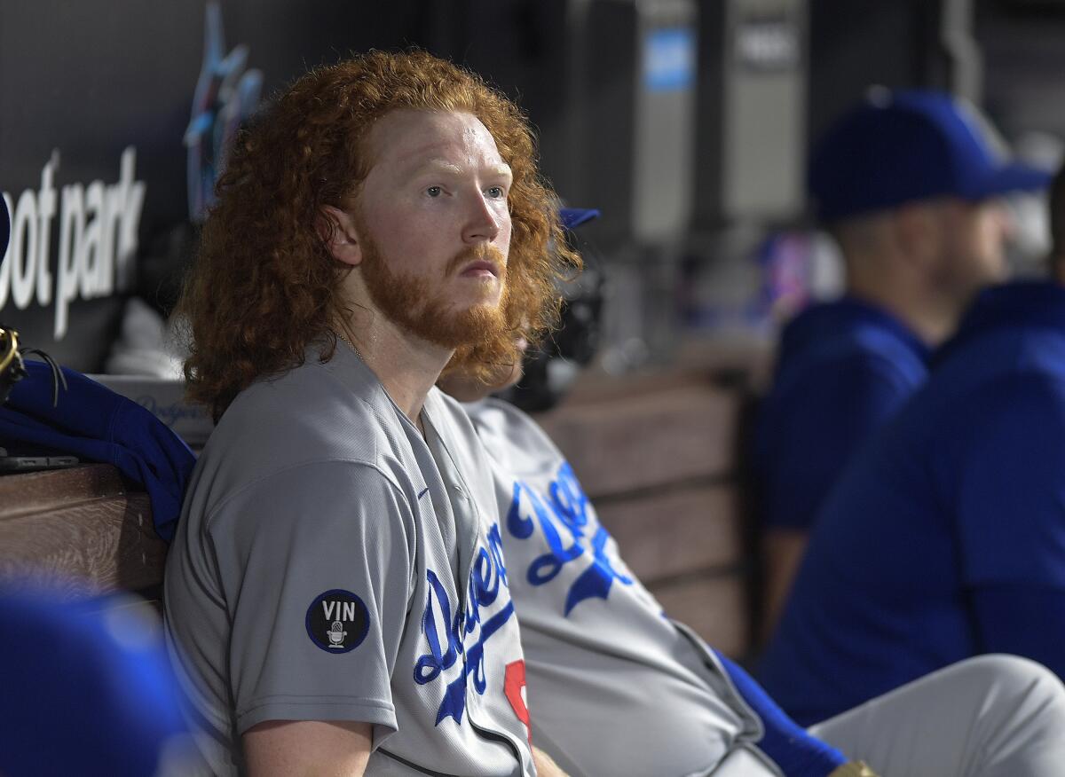 Dodgers starting pitcher Dustin May watches from the dugout during a game against the Miami Marlins on Aug. 27.