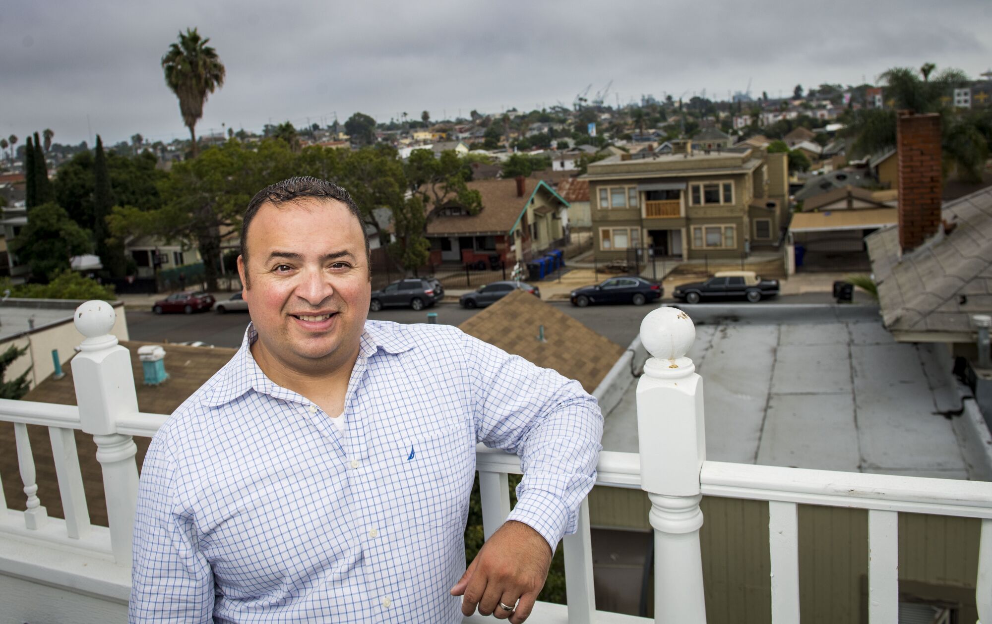 Real estate agent Rafael Perez poses for a photo within the Sherman Heights neighborhood.