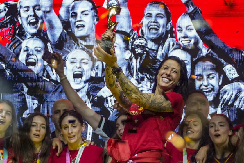 FILE - Spain's Jennifer Hermoso holds the trophy as they celebrate their Women's World Cup victory.