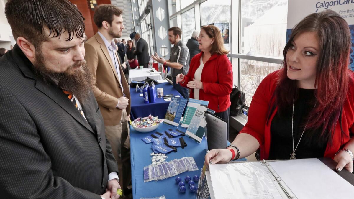 Visitors to a veterans job fair meet with recruiters at Heinz Field in Pittsburgh on March 17.