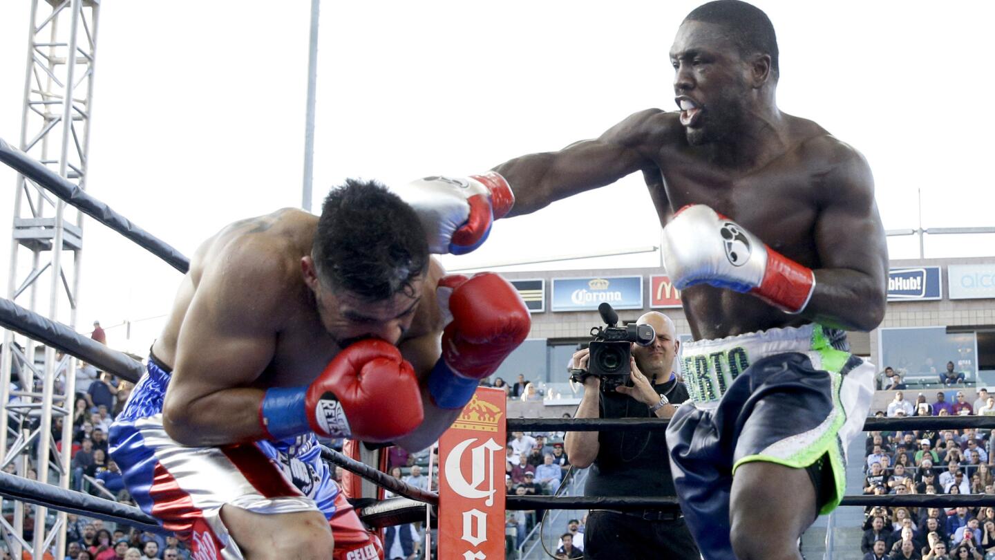 Victor Ortiz, left, can't evade a punch by Andre Berto during the fourth round of their welterweight fight Saturday night at StubHub Center.