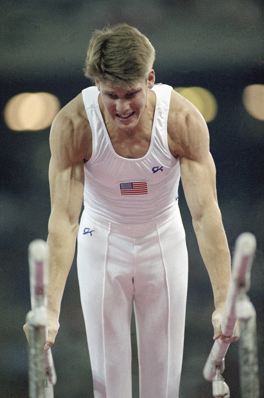 Chris Waller competes on the parallel bars during the men's gymnastics competition at the 1992 Summer Olympics in Barcelona.