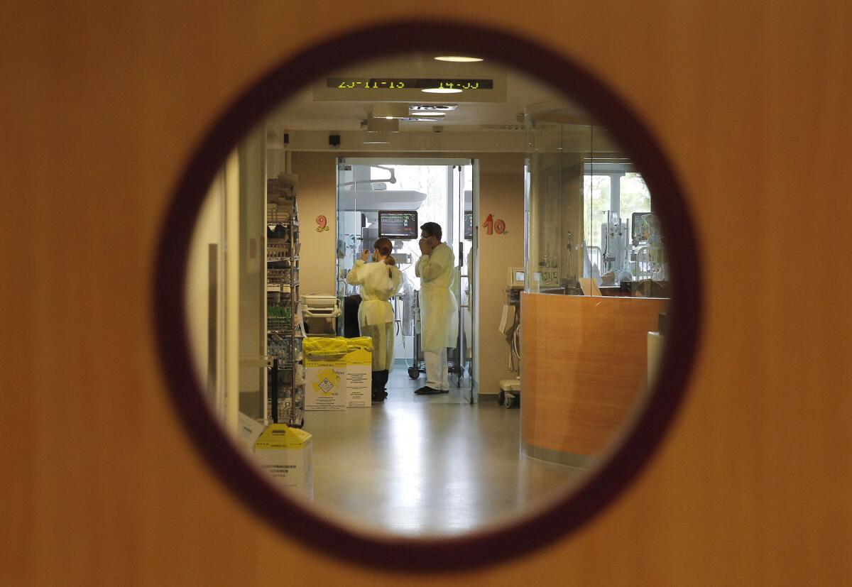 Doctors visit a patient at the intensive care unit of the Queen Fabiola Children's Hospital in Brussels. Belgian lawmakers approved a controversial euthanasia law. If adopted, it will decriminalize euthanasia for children, if they are in great pain, suffer from a terminal condition and are expected to die soon.