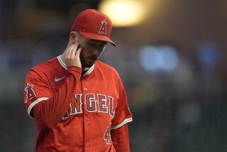 Los Angeles Angels starting pitcher Griffin Canning walks back to the dugout after the second inning of a baseball game against the Minnesota Twins, Tuesday, Sept. 10, 2024, in Minneapolis. (AP Photo/Abbie Parr)