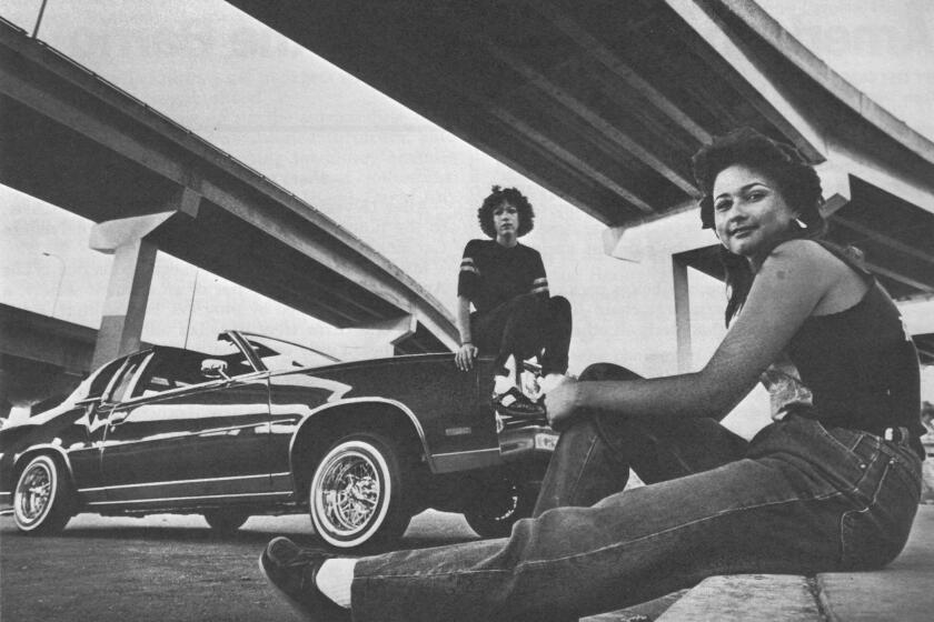 Beneath the Coronado Bridge, Monica Cruz, front, and Marina Garcia visit Chicano Park. 