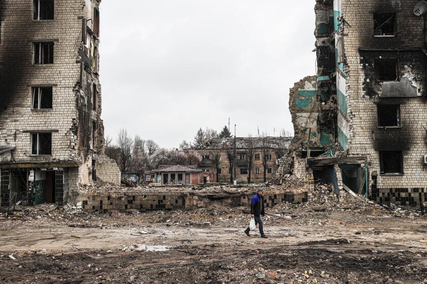 BORODIANKA, UKRAINE - APRIL 22: A Ukrainian walks through the ruins of damaged buildings in Borodianka of Kyiv Oblast of Ukraine on April 22, 2022. (Photo by Metin Aktas/Anadolu Agency via Getty Images)