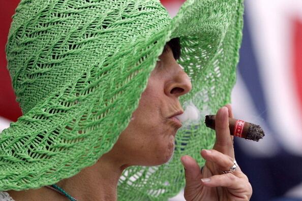 Woman smokes cigar
