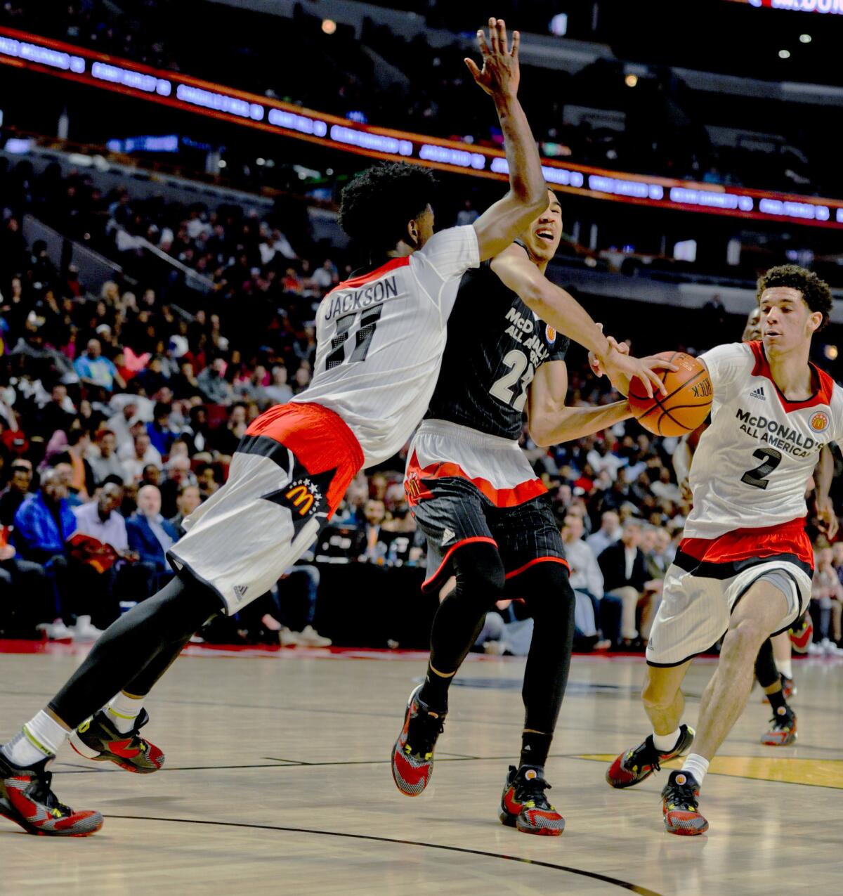 East forward Jayson Tatum (22) from Chaminade College Preparatory school in St. Louis, shoots against West forward Josh Jackson, left, from Justin-Siena High School/Prolific Prep Academy in Napa, Calif., and West point guard Lonzo Ball from Chino Hills High School during the McDonald's All-American game in Chicago.