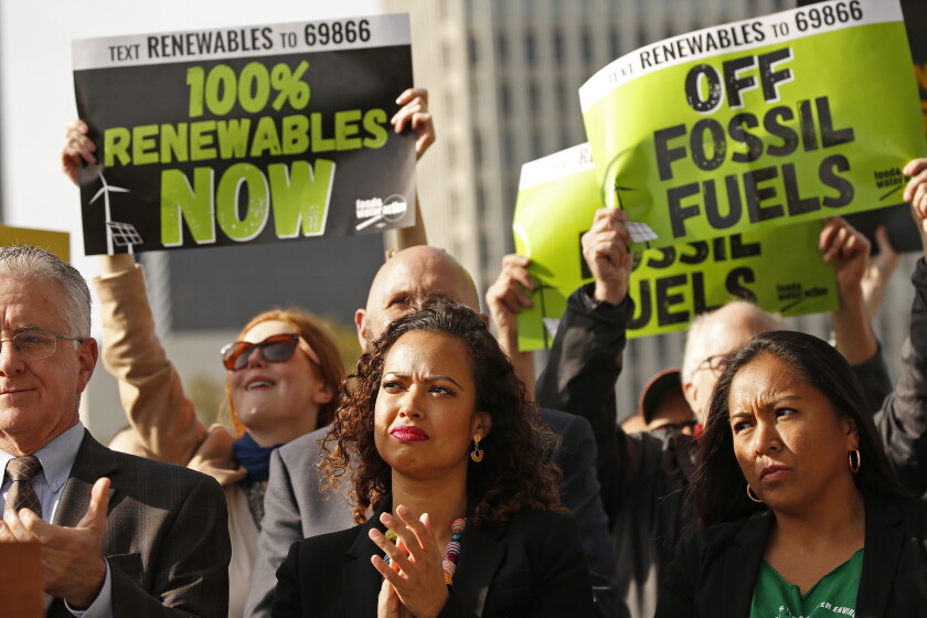Aura Vasquez, then an LADWP commissioner, applauds at a press conference held by Mayor Eric Garcetti.