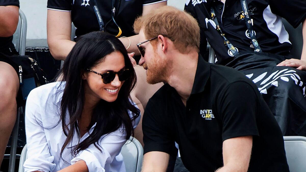 Prince Harry and then-girlfriend Meghan Markle attend the wheelchair tennis competition at the Invictus Games in Toronto in 2017.