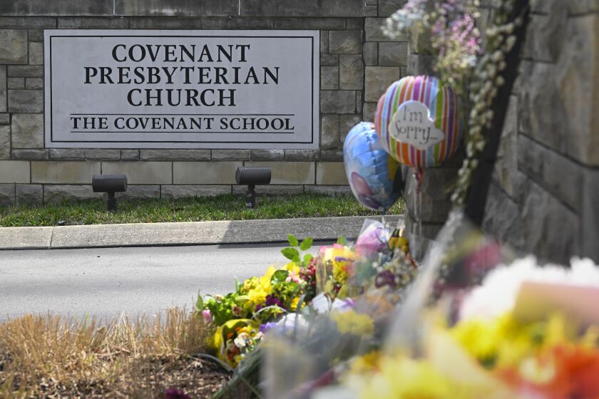 An an entry to Covenant School has become a memorial for shooting victims, Tuesday, March 28, 2023, in Nashville, Tenn. (AP Photo/John Amis)