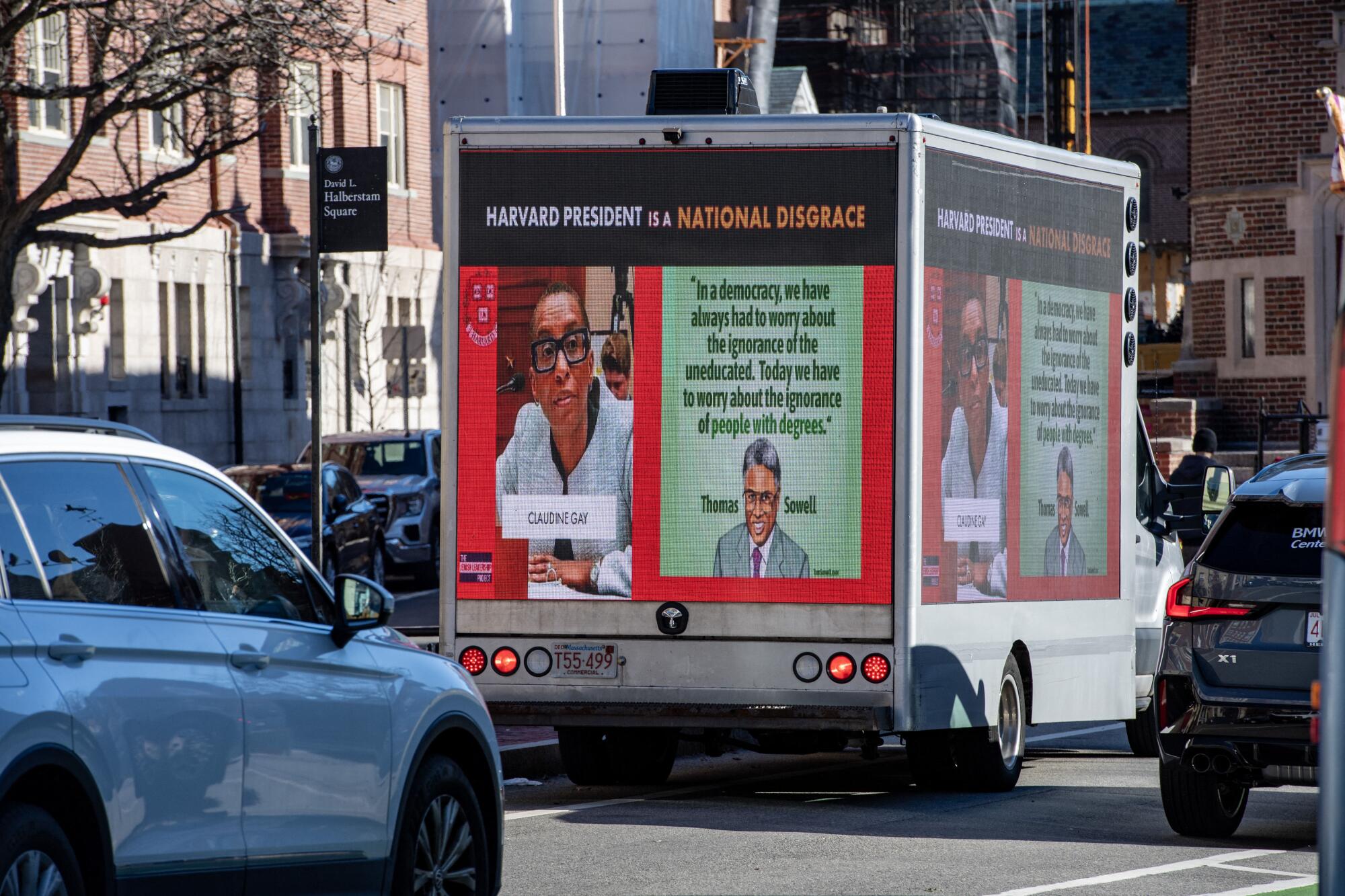 A truck displays a sign denouncing Harvard's president.