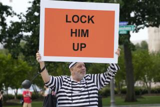 Domenic Santana, 61, of Miami, holds a sign that reads "Lock Him Up" at the E. Barrett Prettyman U.S. Federal Courthouse, Thursday, Aug. 3, 2023, in Washington. Former President Donald Trump is due in federal court in Washington today, to answer charges he sought to overturn his 2020 presidential election loss. (AP Photo/Jacquelyn Martin)