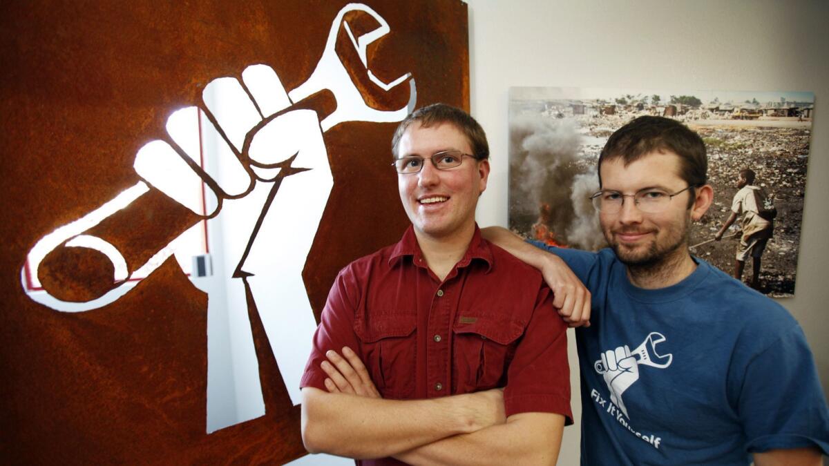 IFixit co-founder Kyle Wiens — left, shown in 2012 with co-founder Luke Soules — said letting third-party repair shops fix smartphones on an owner's behalf is "hugely important" for the aftermarket economy.