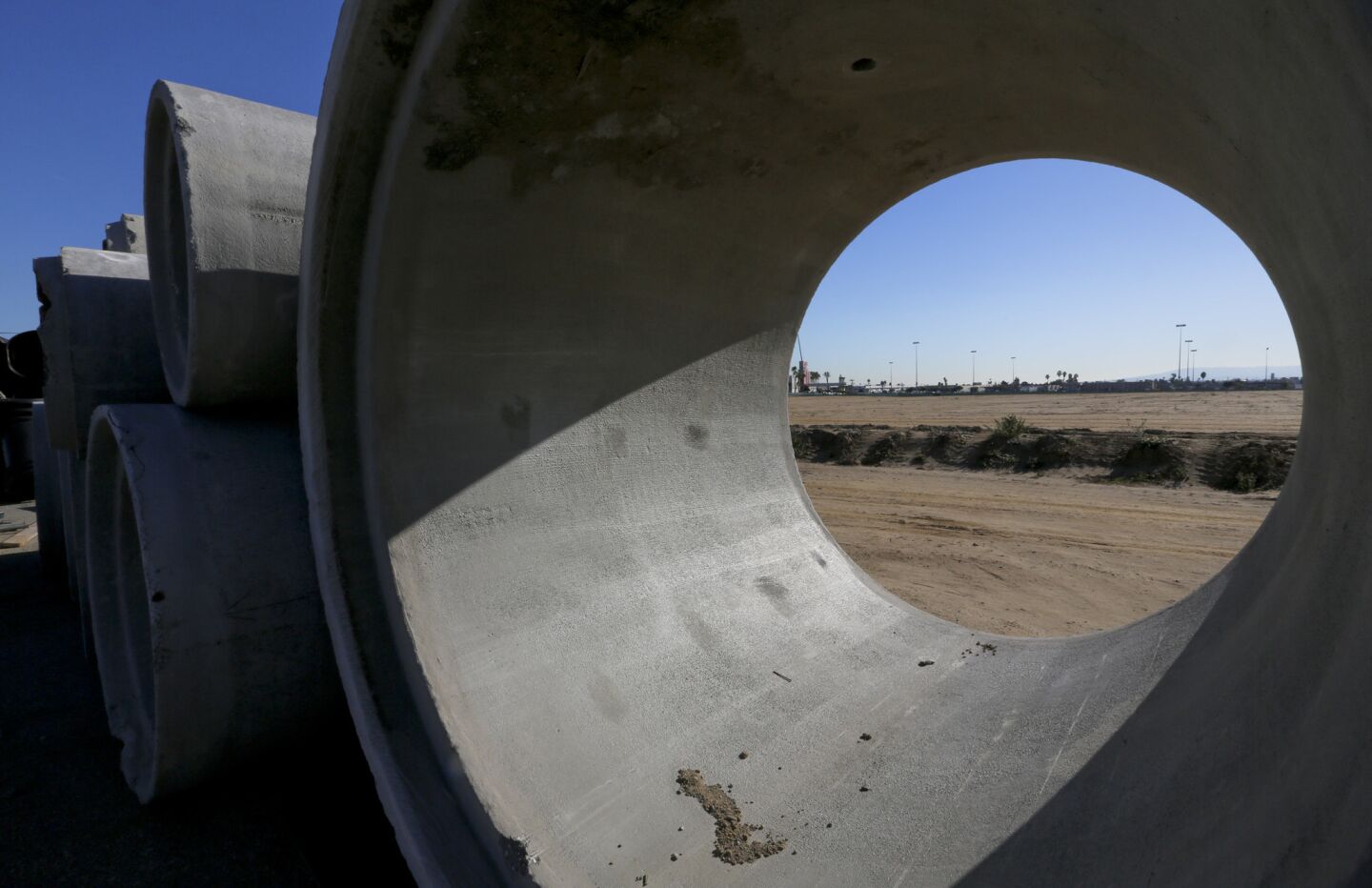 Giant concrete sewer pipes await use at the site of the former Hollywood Park site in Inglewood where an NFL stadium will eventually be constructed.