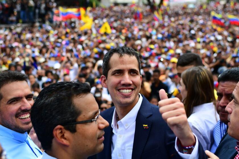 Venezuelan opposition leader and self-proclaimed acting president Juan Guaido gives the thumb up during a rally upon his arrival in Caracas on March 4, 2019. - Venezuela's opposition leader Juan Guaido was mobbed by supporters, media and the ambassadors of allied countries as he returned to Caracas on Monday, defying the threat of arrest from embattled President Nicolas Maduro's regime. Just before his arrival, US Vice President Mike Pence sent a warning to Maduro to ensure Guaido's safety. (Photo by RONALDO SCHEMIDT / AFP)RONALDO SCHEMIDT/AFP/Getty Images ** OUTS - ELSENT, FPG, CM - OUTS * NM, PH, VA if sourced by CT, LA or MoD **