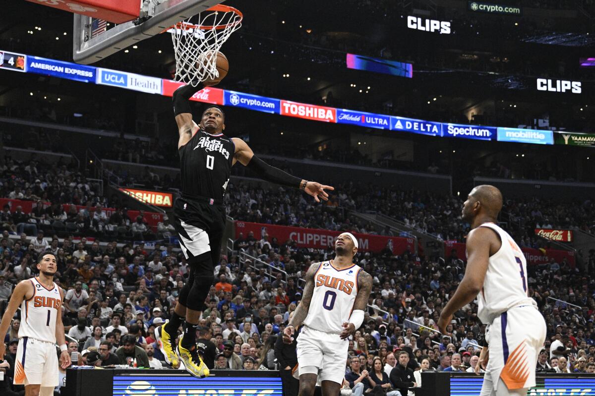 Clippers point guard Russell Westbrook dunks as Phoenix Suns forward Torrey Craig looks on in Game 4.