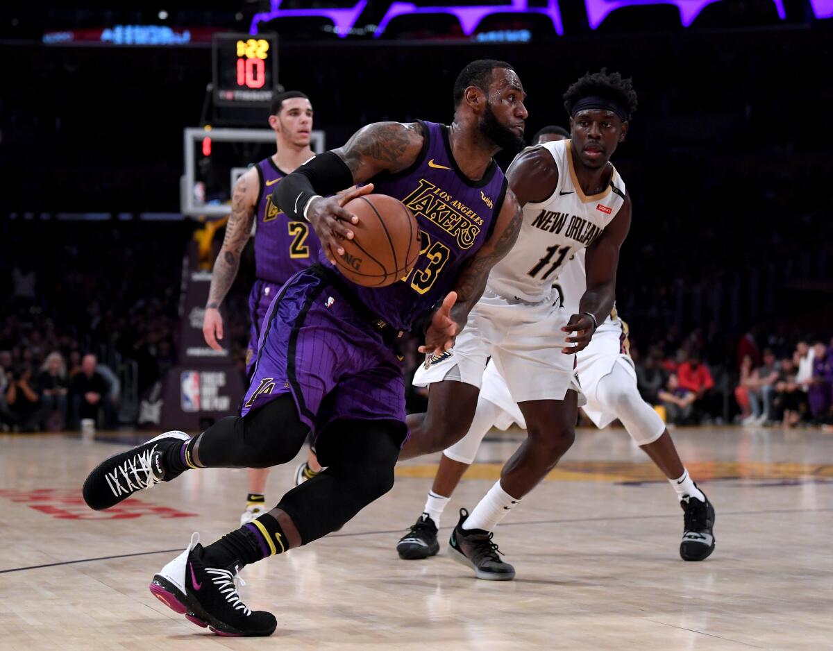 LeBron James of the Los Angeles Lakers drives to the basket on Jrue Holiday of the New Orleans Pelicans during a 112-104 Laker win at Staples Center in Los Angeles on Dec. 21.