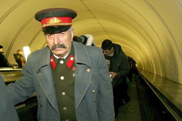 A Josef Stalin impersonator rides a Moscow subway escalator on his way to Red Square, where visitors will have their picture taken with him. The late Soviet dictator is enjoying a renaissance of sorts in Russia.