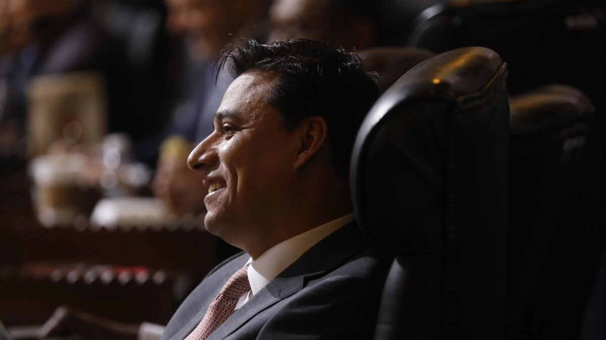 Los Angeles City Councilman Jose Huizar, seated in the council chambers at City Hall on Dec. 11. Federal investigators are looking into the activities of two men as part of their probe of Huizar, sources tell The Times.