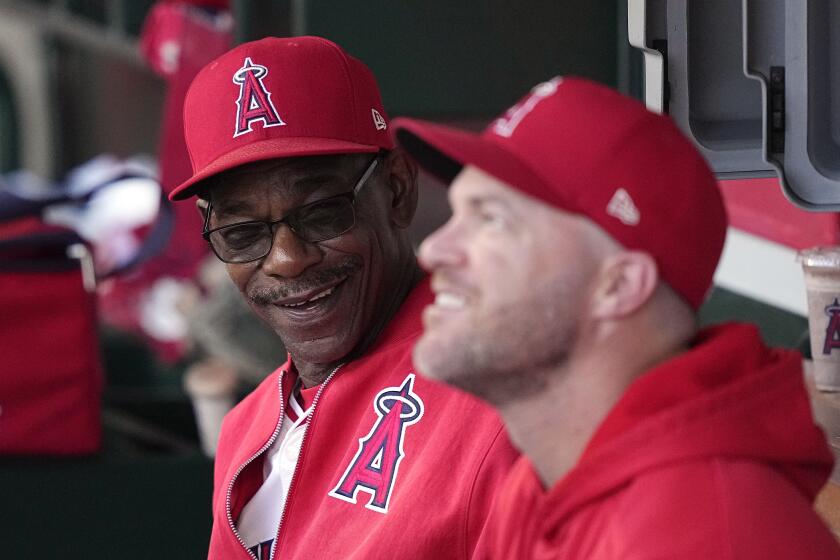 Los Angeles Angels manager Ron Washington, left, talks with assistant coach Jayson Nix prior to the team's baseball game against the New York Yankees on Wednesday, May 29, 2024, in Anaheim, Calif. (AP Photo/Mark J. Terrill)
