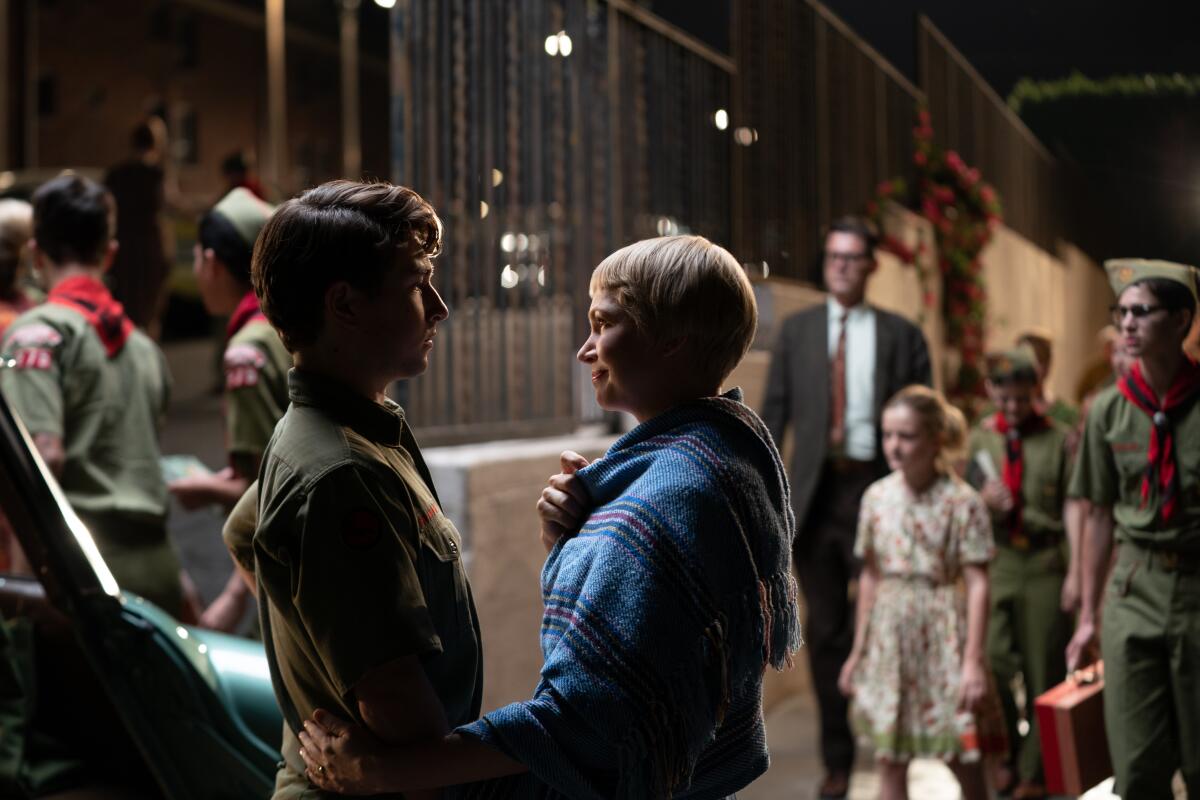 Gabriel LaBelle wears a Boy Scout uniform as he talks with Michelle Williams in a scene from "The Fabelmans."