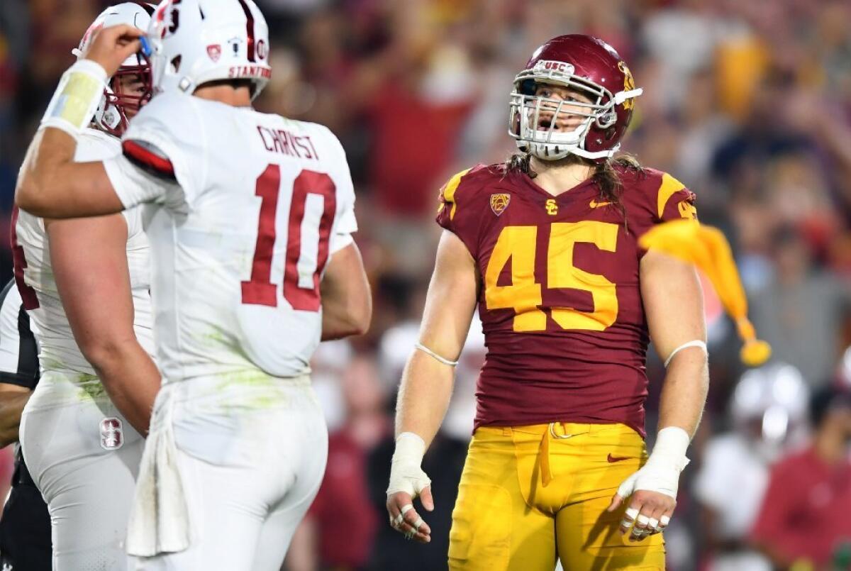 USC linebacker Porter Gustin is called for a roughing a passer penalty on a false start by Stanford during the third quarter of a game at the Coliseum.