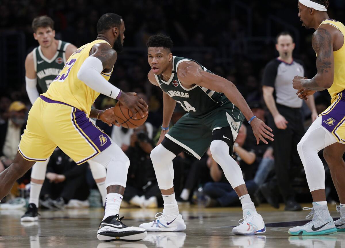 Lakers forward LeBron James (23) is guarded by Bucks forward Giannis Antetokounmpo (34) during a game March 6, 2020.