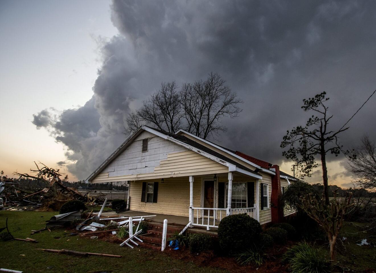 A storm cloud approaches one of the homes damaged by tornadoes near were seven people were killed outside Adel, Georgia, on Jan. 22, 2017.